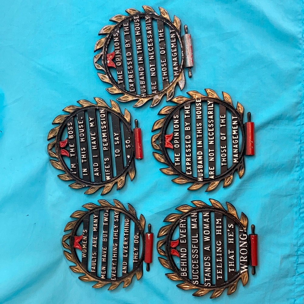Antique trivets, 5 with rolling pin at the bottom.